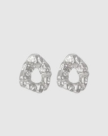 Modern and sculptural, the Castel & Co Remi Earrings in polished silver feature an open, organic form with a textured finish. Their irregular shape adds depth and edge, while the cool silver tone brings a sleek, contemporary feel. A striking statement stud that balances artistry with everyday versatility.

Material: Stainless steel
Closure Type: Stud
Earring Size: 3 x 2.4 cm
Waterproof and hypoallergenic
Weight: 8g