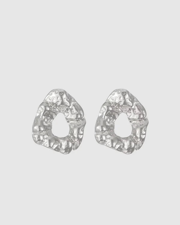 Modern and sculptural, the Castel & Co Remi Earrings in polished silver feature an open, organic form with a textured finish. Their irregular shape adds depth and edge, while the cool silver tone brings a sleek, contemporary feel. A striking statement stud that balances artistry with everyday versatility.

Material: Stainless steel
Closure Type: Stud
Earring Size: 3 x 2.4 cm
Waterproof and hypoallergenic
Weight: 8g