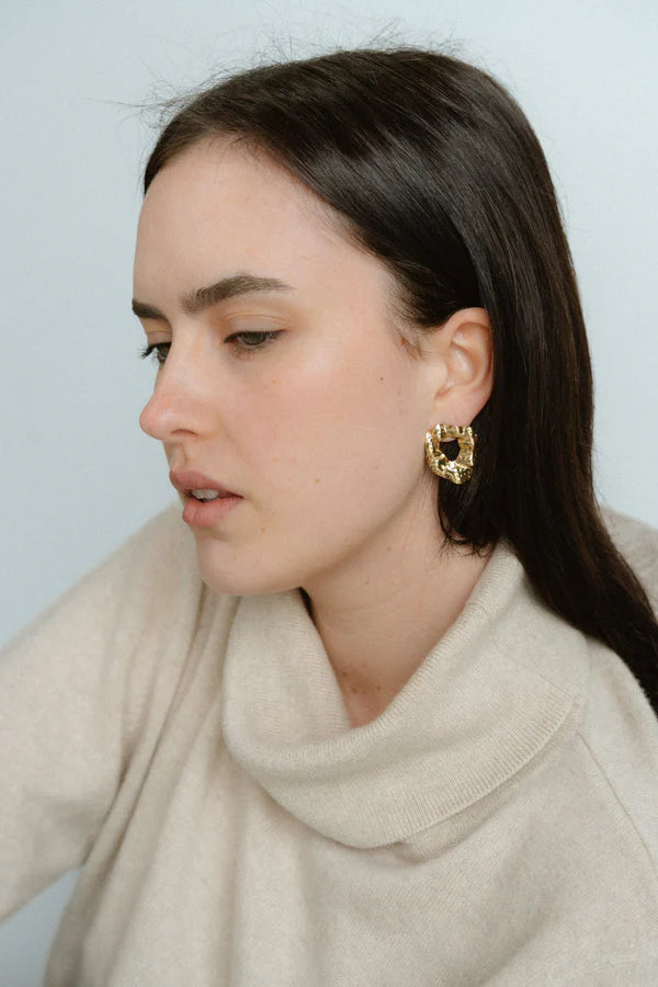 Modern and sculptural, the Castel & Co Remi Earrings in polished silver feature an open, organic form with a textured finish. Their irregular shape adds depth and edge, while the cool silver tone brings a sleek, contemporary feel. A striking statement stud that balances artistry with everyday versatility.

Material: Stainless steel
Closure Type: Stud
Earring Size: 3 x 2.4 cm
Waterproof and hypoallergenic
Weight: 8g