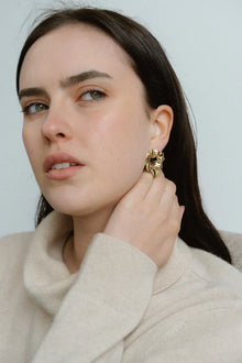 Modern and sculptural, the Castel & Co Remi Earrings in polished silver feature an open, organic form with a textured finish. Their irregular shape adds depth and edge, while the cool silver tone brings a sleek, contemporary feel. A striking statement stud that balances artistry with everyday versatility.

Material: Stainless steel
Closure Type: Stud
Earring Size: 3 x 2.4 cm
Waterproof and hypoallergenic
Weight: 8g