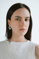 Modern and sculptural, the Castel & Co Remi Earrings in polished silver feature an open, organic form with a textured finish. Their irregular shape adds depth and edge, while the cool silver tone brings a sleek, contemporary feel. A striking statement stud that balances artistry with everyday versatility.

Material: Stainless steel
Closure Type: Stud
Earring Size: 3 x 2.4 cm
Waterproof and hypoallergenic
Weight: 8g