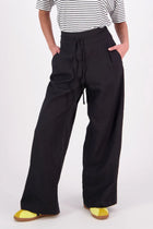 The N-E-S Rita Pant is a full-length take on our bestselling short, crafted in a breathable linen-cotton blend with a relaxed silhouette and subtle front leg pleat. Featuring angled front pockets, a flat front with a decorative drawcord, and an elasticated back waistband for all-day ease. The white colourway includes a half lining in soft cotton voile for added coverage and comfort.

Our model is 174cm and wears a XS (8)

Composition: Linen Cotton

Designed and Made in New Zealand
