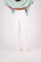 The N-E-S Rita Pant is a full-length take on our bestselling short, crafted in a breathable linen-cotton blend with a relaxed silhouette and subtle front leg pleat. Featuring angled front pockets, a flat front with a decorative drawcord, and an elasticated back waistband for all-day ease. The white colourway includes a half lining in soft cotton voile for added coverage and comfort.

Our model is 174cm and wears a XS (8)

Composition: Linen Cotton

Designed and Made in New Zealand