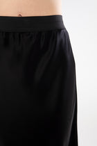 The NES Muse Skirt is the ultimate statement piece—elegant, fluid, and designed to stand out. With a flattering bias cut and a soft concave front that flows into a dropped back hem, this skirt moves beautifully with the body. The wide elasticated waistband offers all-day comfort, while the luxe drape of 100% viscose adds a sophisticated sheen. Multi-seasonal and effortlessly versatile, the Muse Skirt is perfect for pairing with everything from a casual tee to a tailored blazer.