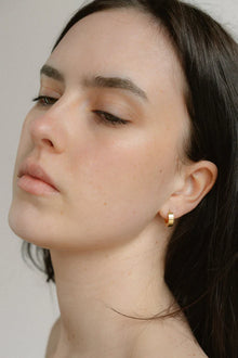 A modern take on the everyday hoop, the Castel & Co Sadie earrings feature a smaller, thicker silhouette that adds just the right amount of boldness. Available in both gold and silver, their clean, polished finish makes them an effortless staple for daily wear.

Material: Stainless steel &amp; Gold Plated
Closure Type: Congo
Earrings Size: 1.3 х 1.2 cm
Waterproof and hypoallergenic
Weight: 3g