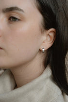 A modern take on the everyday hoop, the Castel & Co Sadie earrings feature a smaller, thicker silhouette that adds just the right amount of boldness. Available in both gold and silver, their clean, polished finish makes them an effortless staple for daily wear.

Material: Stainless steel &amp; Gold Plated
Closure Type: Congo
Earrings Size: 1.3 х 1.2 cm
Waterproof and hypoallergenic
Weight: 3g