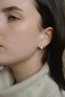 A modern take on the everyday hoop, the Castel & Co Sadie earrings feature a smaller, thicker silhouette that adds just the right amount of boldness. Available in both gold and silver, their clean, polished finish makes them an effortless staple for daily wear.

Material: Stainless steel &amp; Gold Plated
Closure Type: Congo
Earrings Size: 1.3 х 1.2 cm
Waterproof and hypoallergenic
Weight: 3g