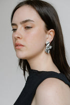 Sculptural and dramatic, the Castel & Co Sienna Earrings feature fluid, folded curves in radiant gold plating. Their bold silhouette and organic form create a striking sense of movement, designed to frame the face with modern artistry. A statement earring that embodies elegance with an edge.

Material: Stainless steel, Gold plating
Closure Type: Stud
Earrings Size: 4.5 x 2.5 cm
Waterproof and hypoallergenic
Weight: 7g