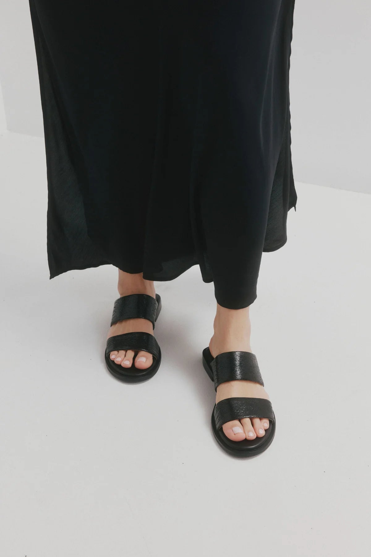 CHAOS &amp; HARMONY | WAVE SLIDE

The WAVE SLIDE in Black Snake features a subtle embossed texture that adds interest to its minimalist form. Designed as a go-to flat leather slide, it’s ideal for everyday wear — clean, easy, and comfortable from the ground up.

Black snake embossed leather slide
Soft leather lined
Black stack heel / black rubber outsole
20mm / 0.78 inch heel
Standard fit
We recommend a good leather/suede protectant to protect your shoes
Made in Dongguan, China