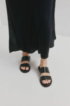 CHAOS &amp; HARMONY | WAVE SLIDE

The WAVE SLIDE in Black Snake features a subtle embossed texture that adds interest to its minimalist form. Designed as a go-to flat leather slide, it’s ideal for everyday wear — clean, easy, and comfortable from the ground up.

Black snake embossed leather slide
Soft leather lined
Black stack heel / black rubber outsole
20mm / 0.78 inch heel
Standard fit
We recommend a good leather/suede protectant to protect your shoes
Made in Dongguan, China