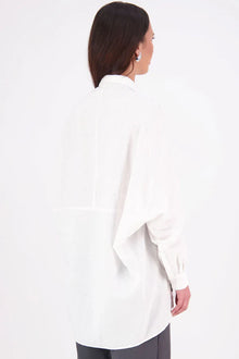 Zola cotton Shirt – Effortless Volume, Elevated Detail

The N-E-S Zola Shirt is a kimono-style oversized shirt with a relaxed, modern silhouette. Featuring a horizontal drop-back panel for added movement, 7/8 sleeves, a classic collar, centre front button placket, and button-up cuffs. A versatile piece that blends structure with flow—perfect for layering or wearing as a statement on its own.
