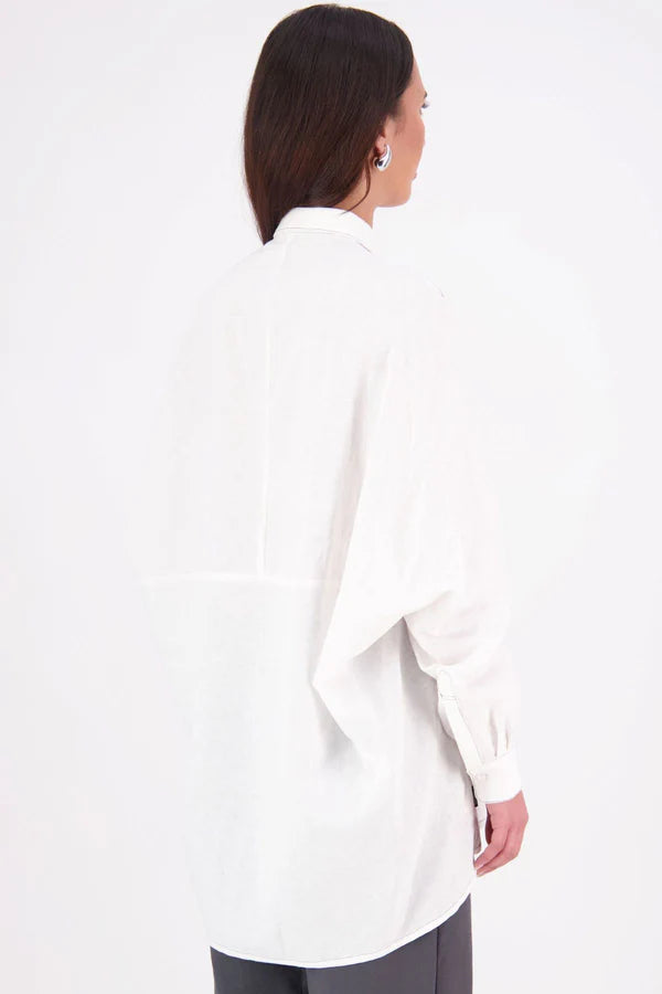 Zola cotton Shirt – Effortless Volume, Elevated Detail

The N-E-S Zola Shirt is a kimono-style oversized shirt with a relaxed, modern silhouette. Featuring a horizontal drop-back panel for added movement, 7/8 sleeves, a classic collar, centre front button placket, and button-up cuffs. A versatile piece that blends structure with flow—perfect for layering or wearing as a statement on its own.