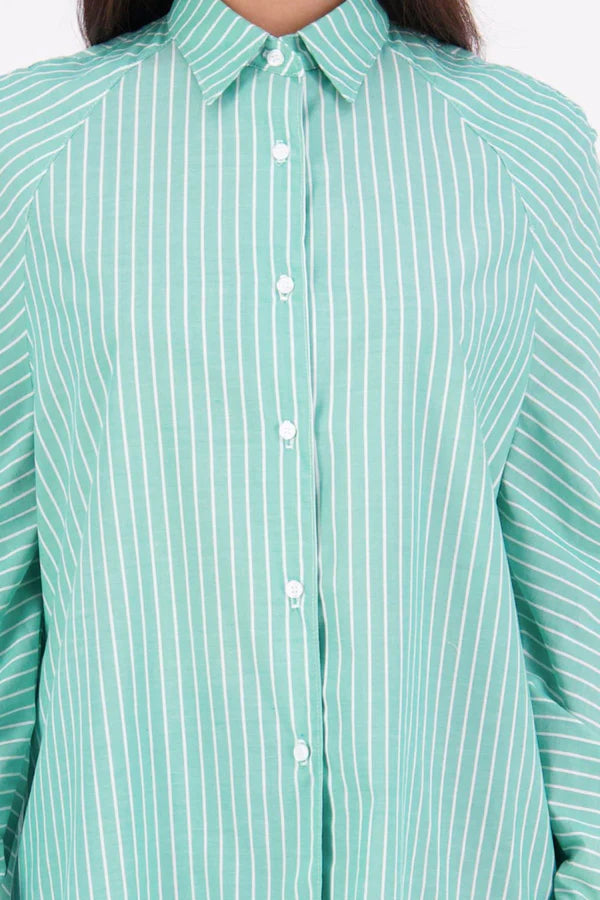 Zola cotton Shirt – Effortless Volume, Elevated Detail

The N-E-S Zola Shirt is a kimono-style oversized shirt with a relaxed, modern silhouette. Featuring a horizontal drop-back panel for added movement, 7/8 sleeves, a classic collar, centre front button placket, and button-up cuffs. A versatile piece that blends structure with flow—perfect for layering or wearing as a statement on its own.