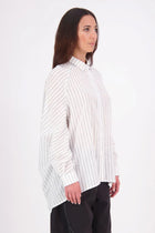 Zola cotton Shirt – Effortless Volume, Elevated Detail

The N-E-S Zola Shirt is a kimono-style oversized shirt with a relaxed, modern silhouette. Featuring a horizontal drop-back panel for added movement, 7/8 sleeves, a classic collar, centre front button placket, and button-up cuffs. A versatile piece that blends structure with flow—perfect for layering or wearing as a statement on its own.