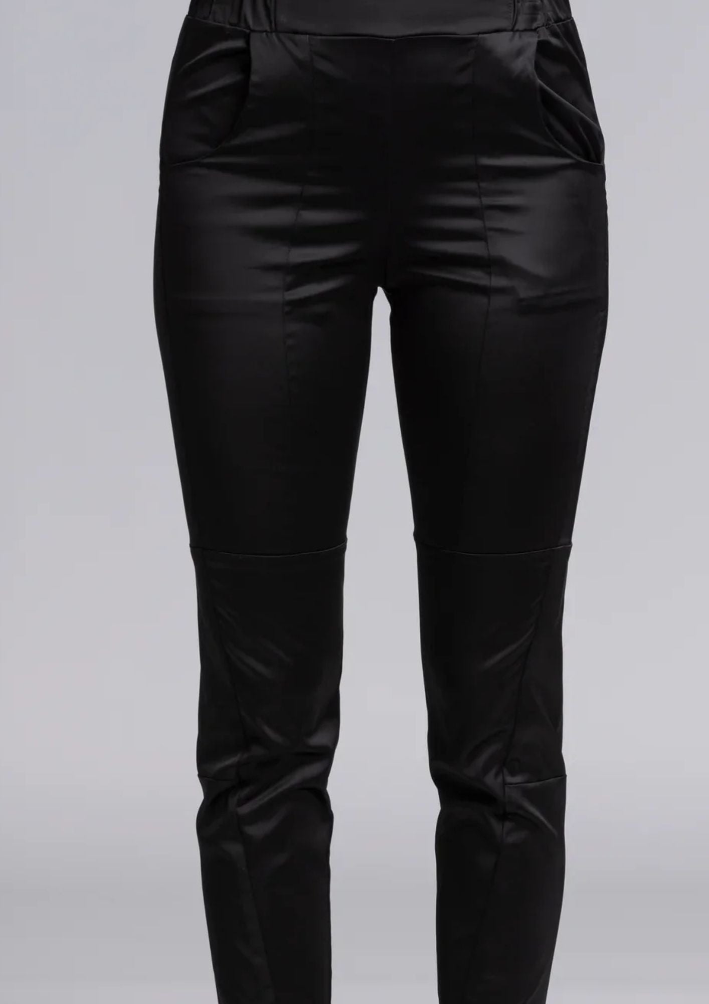 The Satin Section Pant is your go-to slightly more dressy NES essential, offering effortless style and unmatched comfort. With fabulous spliced detailing, this pant combines a sleek flat front with an elasticated back for the perfect fit. Side pockets provide practicality, while the 7/8 length and satin finish add an elevated touch to your look. Whether you're dressing up for a night out, office wear, or a special occasion, these versatile pants can easily be styled for any event. 