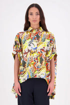 Ryn Shirt – Effortless Volume &amp; Soft Structure

The N-E-S Ryn Shirt is a COTTON SHIRT modern take on a classic, crafted in breathable cotton. With its umbrella-style silhouette, it features a centre front button-down placket, kimono-style sleeves gathered into soft cuffs, and a slight high-low hem. Easy to style back with pants, shorts, or skirts—this is your go-to shirt for relaxed yet elevated dressing.