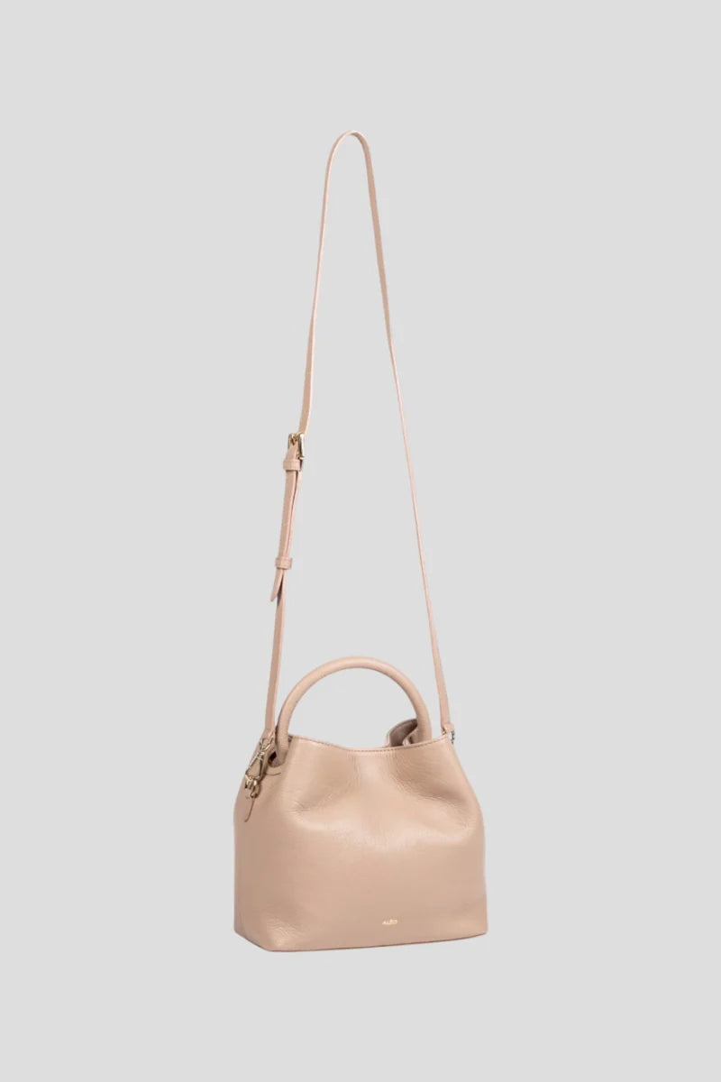 Introducing the ALEO Bon Bon Crossbody Bag, a beautiful fusion of craftsmanship, sustainability, and timeless design. Handcrafted with precision, this bag embodies the essence of slow fashion, using 100% traceable leather for a transparent and ethical approach to luxury. The genuine soft-grained leather finish offers a rich, tactile experience, enhancing both its durability and beauty over time. Genuine soft grained leather finish&nbsp;
Tote shaped bag w/ tonal handle
Detachable tonal crossbody strap