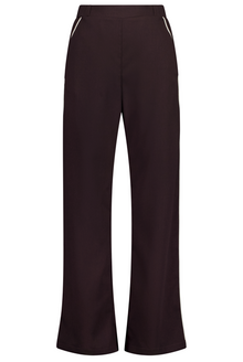N-E-S Double Piped Gin Pants, designed and made in NZ – women’s classic straight-cut pants in a breathable cotton blend (99% wool, 1% Lycra) with flat front, elasticated back waistband, angled side pockets, and subtle piping along side seams and diagonal pocket edges; 32" length, versatile for work, weekends, or dress-up wear, in Plum.