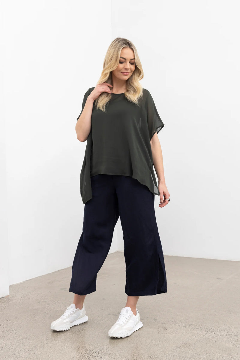 NES Civita Top – Relaxed, Flowing &amp; Versatile

The Civita Top is an effortlessly stylish, oversized piece crafted from lightweight chiffon. Featuring contrast piping along the front vertical seam and split side detailing, this top offers multiple styling options. Tie the sides for a more defined silhouette or tuck it in for a relaxed, easy-going look. Perfect for layering or wearing solo, it transitions seamlessly from day to night, making it ideal for any season. PT CHIFFON nes lattice singlet