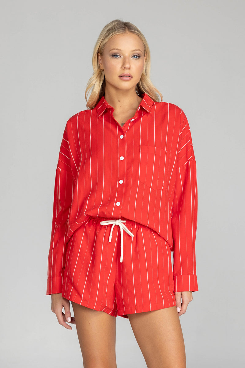 Elevate your style with this must-have BLAK Defiant shirt! Made from a striking red with white pinstripe high quality tencel linen, its relaxed fit and timeless details will make you feel effortlessly cool and infinitely chic. Featuring a drop shoulder, an inverted box pleat in the back, working sleeve cuffs, and a scooped hem, it's a true classic that will fast become your go to shirt.