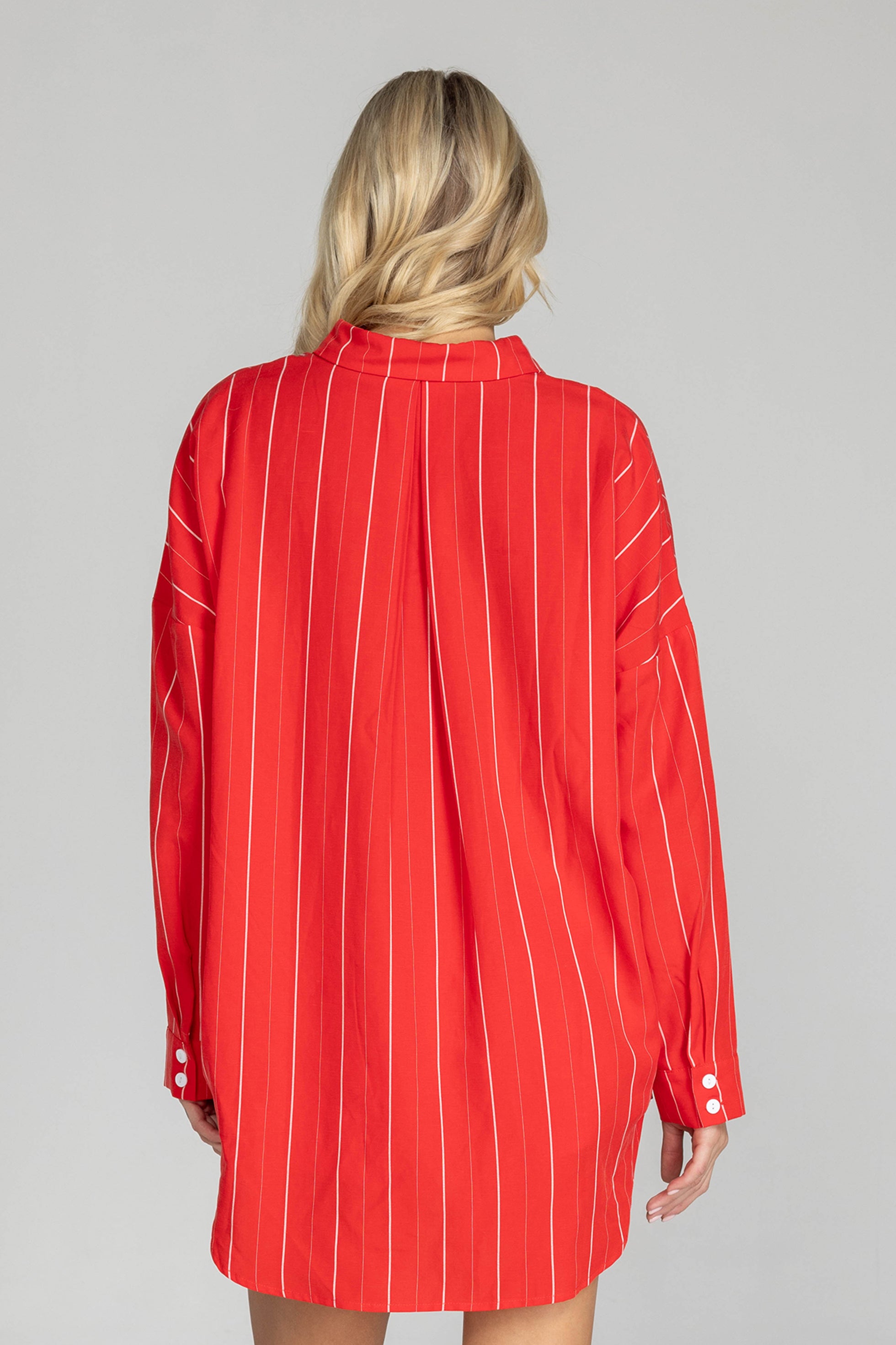 Elevate your style with this must-have BLAK Defiant shirt! Made from a striking red with white pinstripe high quality tencel linen, its relaxed fit and timeless details will make you feel effortlessly cool and infinitely chic. Featuring a drop shoulder, an inverted box pleat in the back, working sleeve cuffs, and a scooped hem, it's a true classic that will fast become your go to shirt.