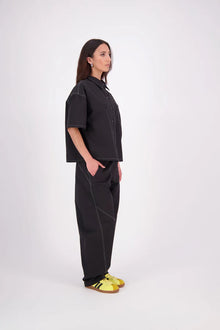 The N-E-S Demi Shirt is your ultimate summer must-have, blending a utilitarian edge with everyday versatility. Designed as a short-sleeve, boxy-fit shacket, it features a button-down front, single breast pocket, and elbow-length sleeves. Wear it open or closed—perfect for layering or styling solo through the warmer months.

Our model is 174cm and wear a XS/S (8-10)

Composition: Kale pop - cotton twill | Black - cotton, nylon

Designed and Made in New Zealand