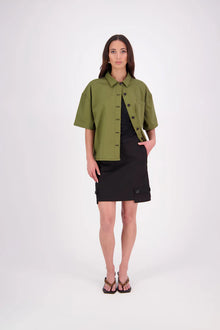 The N-E-S Demi Shirt is your ultimate summer must-have, blending a utilitarian edge with everyday versatility. Designed as a short-sleeve, boxy-fit shacket, it features a button-down front, single breast pocket, and elbow-length sleeves. Wear it open or closed—perfect for layering or styling solo through the warmer months.

Our model is 174cm and wear a XS/S (8-10)

Composition: Kale pop - cotton twill | Black - cotton, nylon

Designed and Made in New Zealand