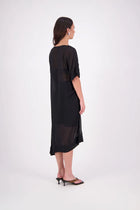 The N-E-S Em Dress is a statement style crafted in lightweight chiffon, designed with ruching and a drawcord that lets you adjust the length to suit your look. Featuring a cap sleeve on the left and a cuffed short sleeve on the right, it embraces asymmetry with a wide cuff hem for added edge. Floaty yet bold, the Em Dress is your go-to for elevated, directional dressing.

Our model is 174cm and wears a XS (8)
NES fit advise: Standard fit

Composition: PT Chiffon

Designed and Made in New Zealand