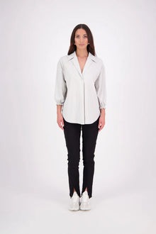 The N-E-S Fara Shirt blends classic tailoring with soft, modern touches. Featuring 7/8 sleeves with three layers of shirring at the cuffs, a traditional collar flowing into an open V-neck and centre front pleat. The drop-back design reveals a cross-over keyhole and centre back button detail. Style the sleeves your way—worn down, ruched up, or tucked under—for versatile, effortless dressing.
Composition: Sky (fine seersucker) - cotton, spandex | Oyster grey stripe cotton, polyamide, elastine.