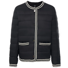 Fern by Moke women’s down puffer jacket in black and olive green. Bold, modern winter coat filled with 90 percent duck down and 10 percent waterfowl feathers for lightweight warmth. Features crochet knit trim at the hems and cuffs, exposed snap front closure with branded metal hardware, and a refined silhouette designed in New Zealand for elevated everyday cold weather wear.