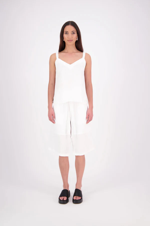 The N-E-S Rita Short is an easy update to our classic Gin Short, crafted in a breathable linen-cotton blend. Featuring a single front leg pleat for subtle shape, angled front pockets, and an elasticated back waistband for comfort. A decorative front drawcord adds detail, with a length finishing just below the knee—perfect for relaxed yet polished summer dressing.

White colourway has a 1/2 liner in a cotton voile
Our model is 174cm and wear a XS (8)
Composition: Linen Cotton
Designed and Made in New Zealand