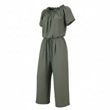 The N-E-S Muses Jumpsuit features a shirred off-the-shoulder top with cap sleeves, an elasticated back waist, and a self-drawcord front for a flattering, adjustable fit. The lower half mirrors the relaxed fit of our Lounge Jumpsuit, with angled seams, centre front detailing, and practical front pockets