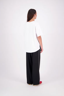 We’ve had some fun with our NES Gin Pants, adding a contrast side seam piping detail for a stylish twist on a classic design. These pants feature a flattering, classic cut that’s perfect for both dressing up and down, making them an ideal work pant and an effortless everyday style. With a flat front, covered elasticated back, and flattering angled pockets, they offer both comfort and sophistication.
Composition: 100% Polyester
Designed & Made in New Zealand
