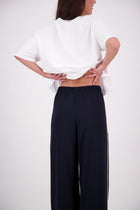 We’ve had some fun with our NES Gin Pants, adding a contrast side seam piping detail for a stylish twist on a classic design. These pants feature a flattering, classic cut that’s perfect for both dressing up and down, making them an ideal work pant and an effortless everyday style. With a flat front, covered elasticated back, and flattering angled pockets, they offer both comfort and sophistication.
Composition: 100% Polyester
Designed & Made in New Zealand