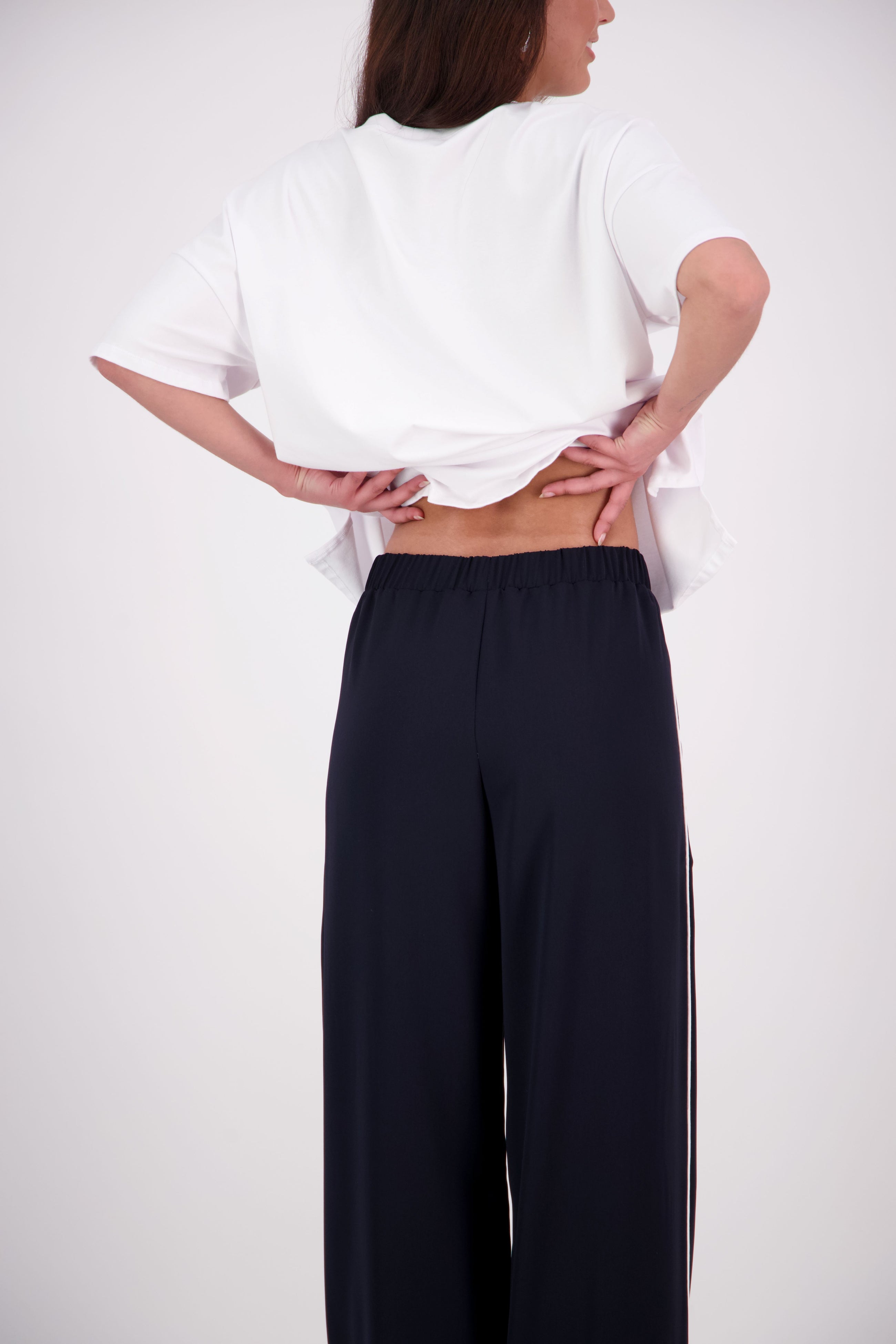We’ve had some fun with our NES Gin Pants, adding a contrast side seam piping detail for a stylish twist on a classic design. These pants feature a flattering, classic cut that’s perfect for both dressing up and down, making them an ideal work pant and an effortless everyday style. With a flat front, covered elasticated back, and flattering angled pockets, they offer both comfort and sophistication.
Composition: 100% Polyester
Designed & Made in New Zealand