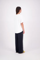 We’ve had some fun with our NES Gin Pants, adding a contrast side seam piping detail for a stylish twist on a classic design. These pants feature a flattering, classic cut that’s perfect for both dressing up and down, making them an ideal work pant and an effortless everyday style. With a flat front, covered elasticated back, and flattering angled pockets, they offer both comfort and sophistication.
Composition: 100% Polyester
Designed & Made in New Zealand