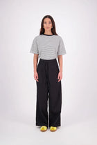 The N-E-S Rita Pant is a full-length take on our bestselling short, crafted in a breathable linen-cotton blend with a relaxed silhouette and subtle front leg pleat. Featuring angled front pockets, a flat front with a decorative drawcord, and an elasticated back waistband for all-day ease. The white colourway includes a half lining in soft cotton voile for added coverage and comfort.

Our model is 174cm and wears a XS (8)

Composition: Linen Cotton

Designed and Made in New Zealand