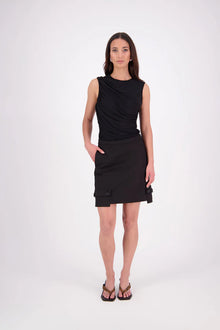 The N-E-S Demi Skirt is a fresh take on utilitarian style, reimagined as a flattering mini. Designed with a curved waistband for a versatile fit across body shapes, it features side seam pockets, a concealed centre back zip, and bold hem pocket detailing with Black buttons. Falling just above the knee, it’s the perfect mix of function and style.

Our model is 174cm and wear a XS (8)

Composition: cotton, spandex&nbsp;

Designed and Made in New Zealand
