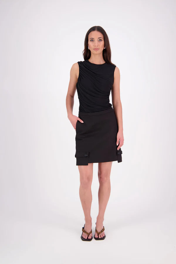 The N-E-S Demi Skirt is a fresh take on utilitarian style, reimagined as a flattering mini. Designed with a curved waistband for a versatile fit across body shapes, it features side seam pockets, a concealed centre back zip, and bold hem pocket detailing with Black buttons. Falling just above the knee, it’s the perfect mix of function and style.

Our model is 174cm and wear a XS (8)

Composition: cotton, spandex&nbsp;

Designed and Made in New Zealand