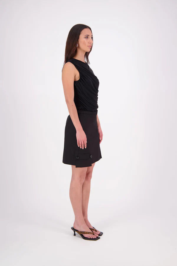 The N-E-S Demi Skirt is a fresh take on utilitarian style, reimagined as a flattering mini. Designed with a curved waistband for a versatile fit across body shapes, it features side seam pockets, a concealed centre back zip, and bold hem pocket detailing with Black buttons. Falling just above the knee, it’s the perfect mix of function and style.

Our model is 174cm and wear a XS (8)

Composition: cotton, spandex&nbsp;

Designed and Made in New Zealand