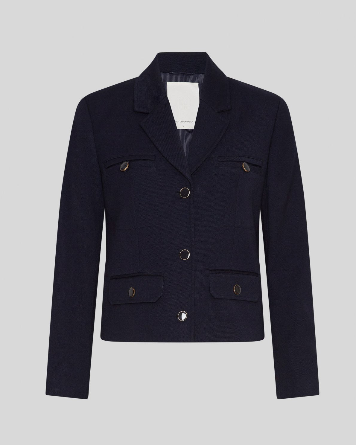 MSCH | ELINA BLAZER

A short, navy blue blazer with dark blue buttons with gold rim. These buttons is both down the front and on the cuffs. The blazer features a front pocket design inspired by a military jacket. Style it with a pair of jeans for a cool and causal look or with the matching skirt.

This blazer has a boxy fit. The model is 177cm and wears a size S.

Composition: 50% Recycled Polyester, 35% Viscose &amp; 15% Polyester