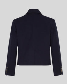 MSCH | ELINA BLAZER

A short, navy blue blazer with dark blue buttons with gold rim. These buttons is both down the front and on the cuffs. The blazer features a front pocket design inspired by a military jacket. Style it with a pair of jeans for a cool and causal look or with the matching skirt.

This blazer has a boxy fit. The model is 177cm and wears a size S.

Composition: 50% Recycled Polyester, 35% Viscose &amp; 15% Polyester