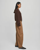 MSCH Copenhagen GWENETH DW Pants in a rich caramel colour with a high waist and relaxed regular fit barrel-leg silhouette. Designed with front pleats, elastic side inserts, belt loops, button and zip closure, and back flap pockets with button detailing. Crafted from a soft lyocell and cotton blend for effortless everyday wear.