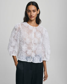 MSCH Copenhagen ISMENE 3/4 Shirt EMB in white, crafted from a lightweight semi-sheer fabric with delicate embroidered floral detailing. Designed with a round neckline and full front button closure, featuring 3/4-length volume sleeves with elastic cuffs and an oversized airy fit.