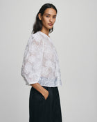 MSCH Copenhagen ISMENE 3/4 Shirt EMB in white, crafted from a lightweight semi-sheer fabric with delicate embroidered floral detailing. Designed with a round neckline and full front button closure, featuring 3/4-length volume sleeves with elastic cuffs and an oversized airy fit.
