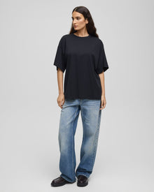 MSCH Kinsey Melea Tee in black by MSCH Copenhagen. Oversized organic cotton T-shirt with a round neckline, dropped shoulders and short sleeves for a relaxed boxy fit. Soft everyday staple in 100% organic cotton.