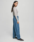 MSCH Copenhagen KOBANE LIS Barrel Jeans in washed blue denim with a loose barrel-leg fit, mid waist and tapered ankle. Features classic five-pocket styling, visible stitching, belt loops and zip button closure.