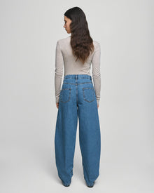 MSCH Copenhagen KOBANE LIS Barrel Jeans in washed blue denim with a loose barrel-leg fit, mid waist and tapered ankle. Features classic five-pocket styling, visible stitching, belt loops and zip button closure.
