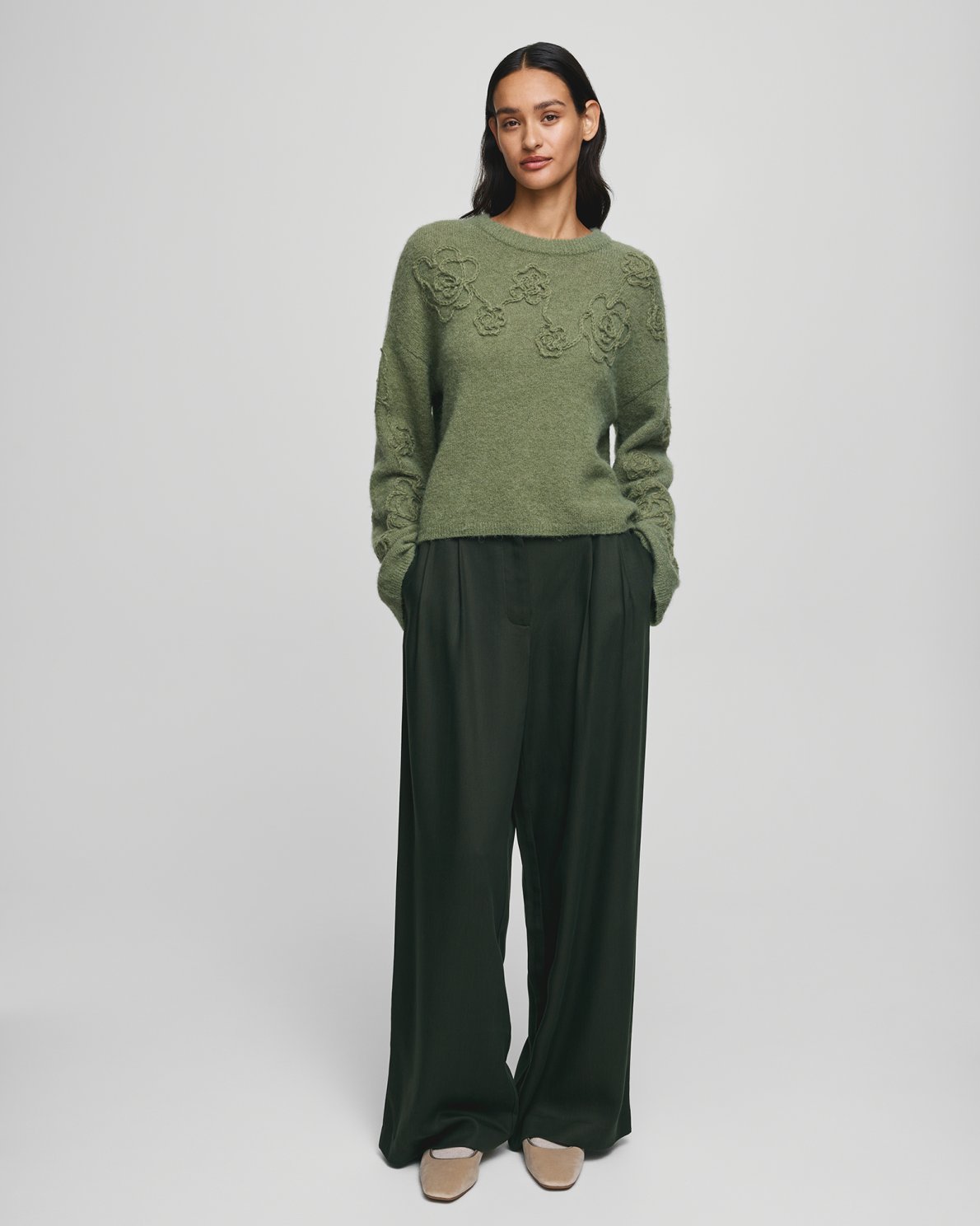 MSCH Copenhagen Miabelle Hope Pullover EMB in muted olive green with embroidered floral detailing and a relaxed boxy fit. Designed with a round neckline and classic long sleeves, crafted from a soft blend of wool, alpaca, acrylic, recycled polyester, polyester, and elastane for a cosy everyday feel.