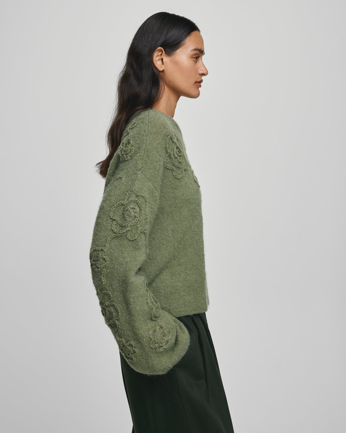 MSCH Copenhagen Miabelle Hope Pullover EMB in muted olive green with embroidered floral detailing and a relaxed boxy fit. Designed with a round neckline and classic long sleeves, crafted from a soft blend of wool, alpaca, acrylic, recycled polyester, polyester, and elastane for a cosy everyday feel.